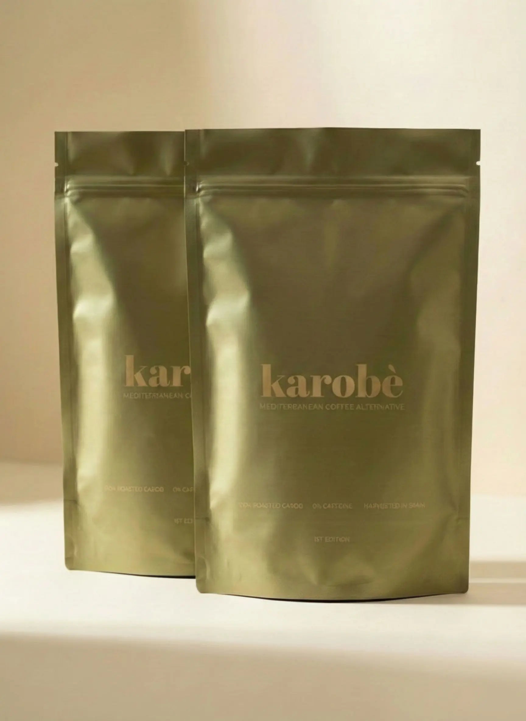 Two packages of Karobe roasted carob powder, a premium natural caffeine-free coffee alternative.